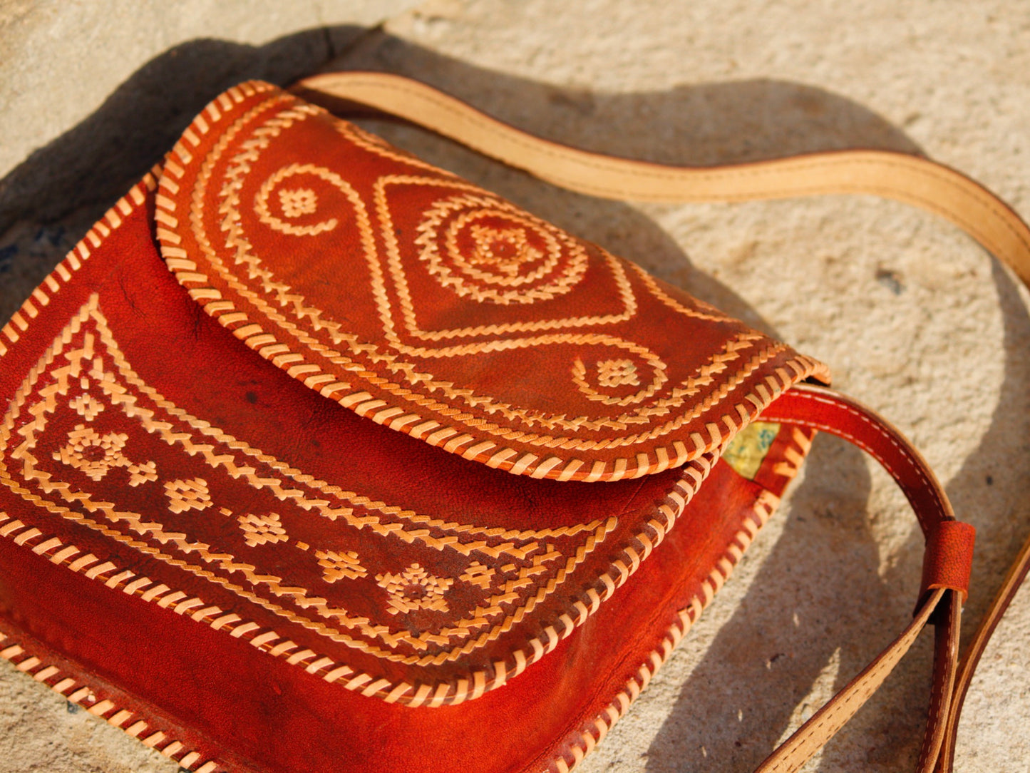 Elegant leather bag with embroidered accents and durable leather construction