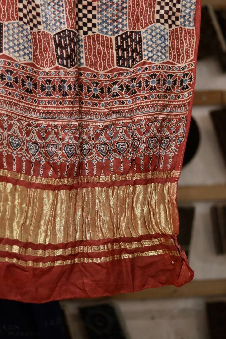 Traditional brick red Ajrakh modal silk dupatta showcasing authentic artisan craftsmanship and decorative borders