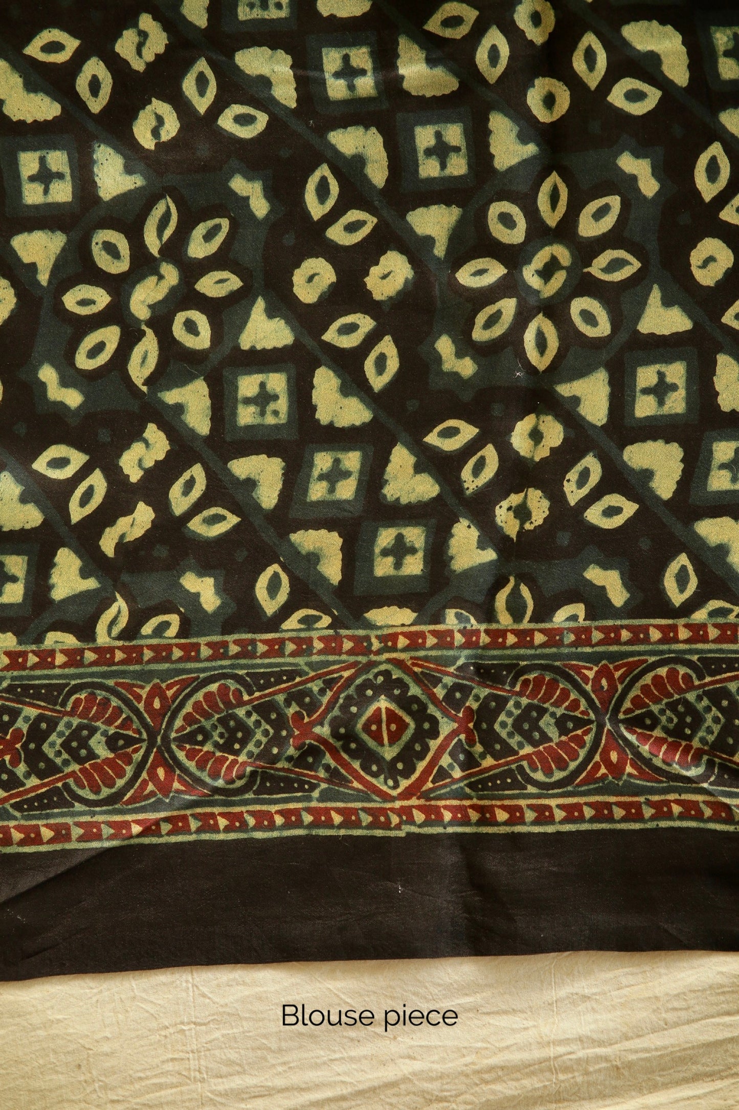 Premium bottle green modal silk saree with heritage-inspired Ajrakh designs and graceful fall. Traditional bottle green Ajrakh printed modal silk saree crafted by skilled artisans with refined detailing