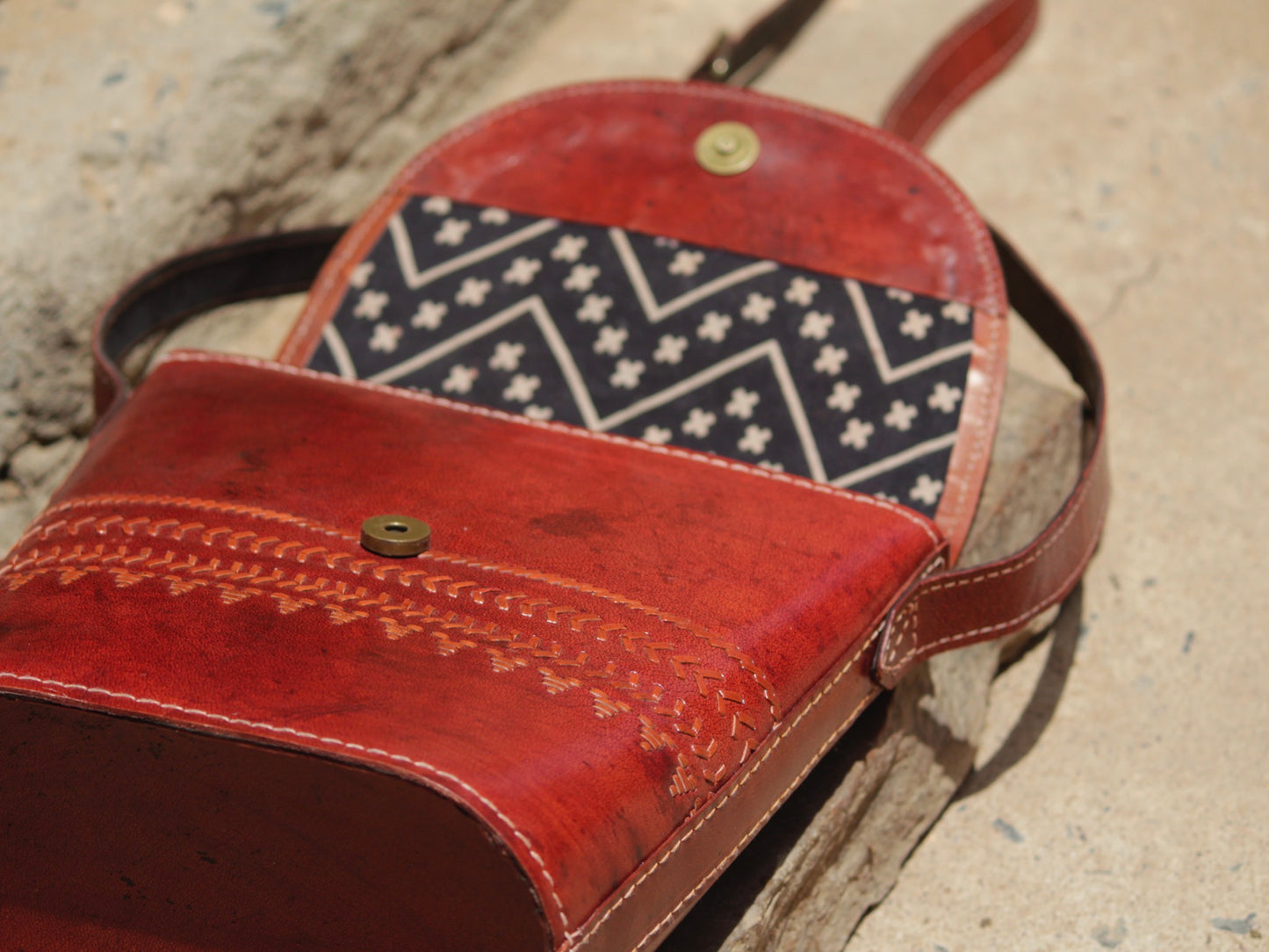 Premium leather bag combining skilled leatherwork with artistic thread detailing