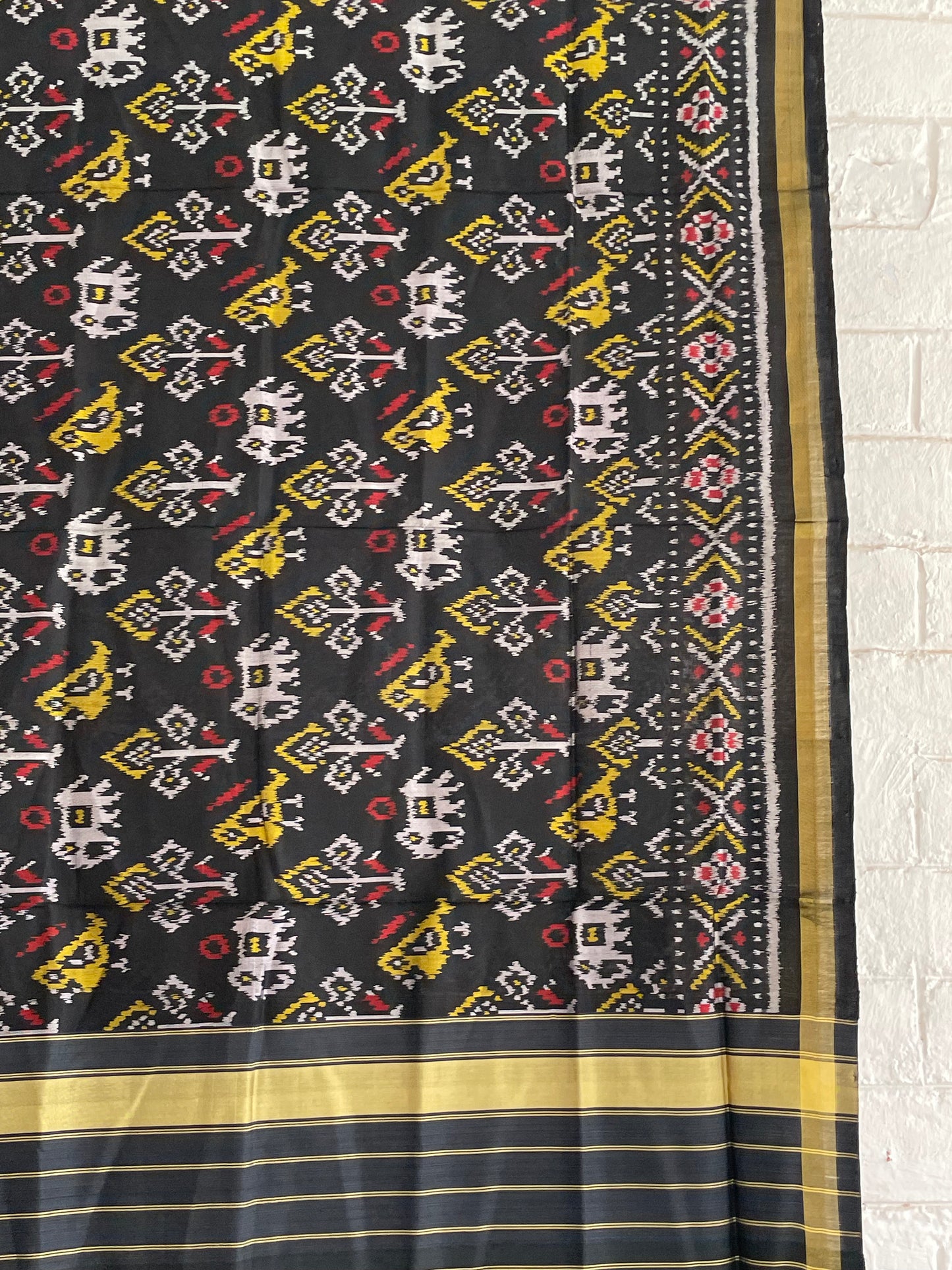 Handcrafted black Patola dupatta showcasing authentic Single Ikkat weaving artistry