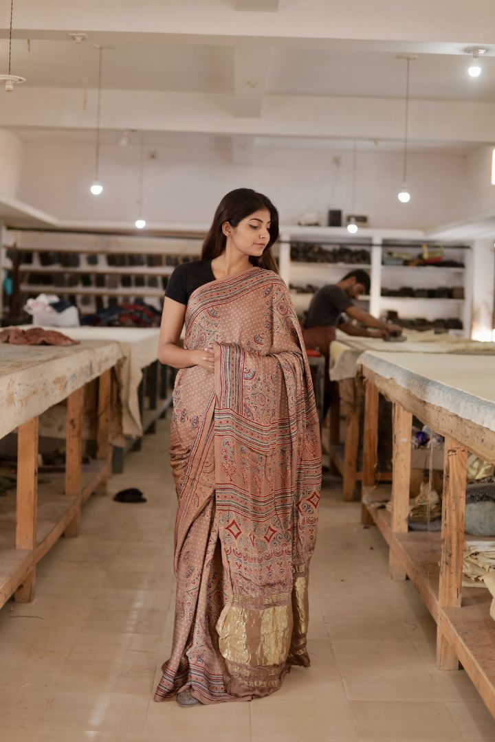 Elegant dusty brown Ajrakh saree crafted in luxurious modal silk with heritage-inspired designs and zari border