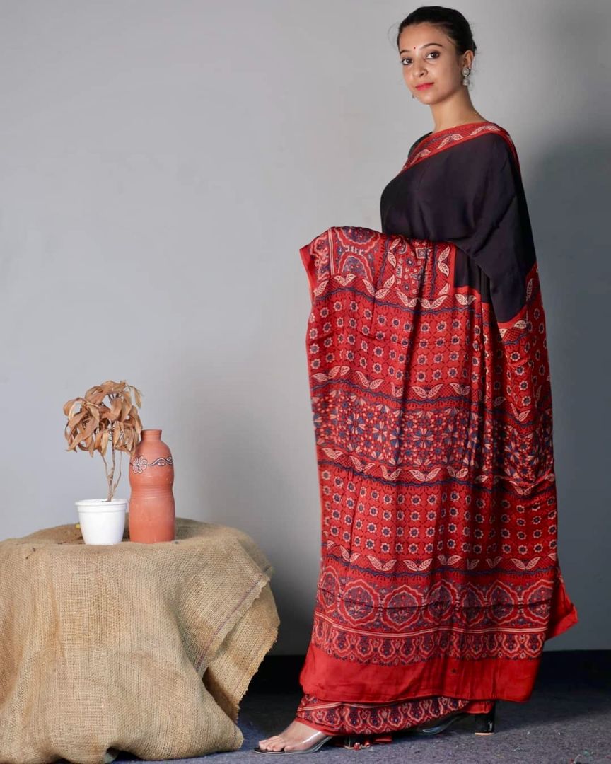 Handcrafted black and red modal silk saree adorned with traditional Ajrakh patterns and rich detailing