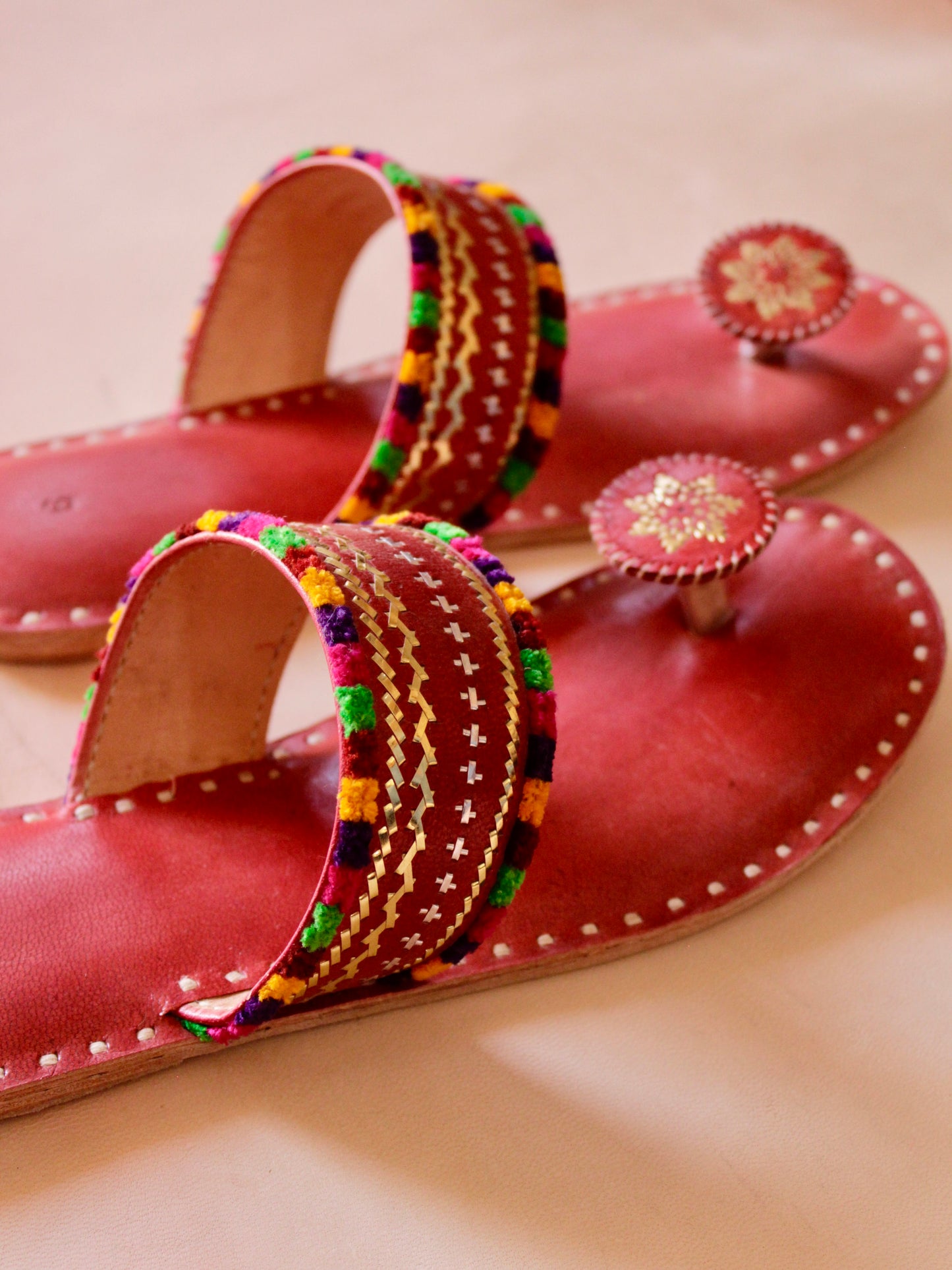 Premium red handcrafted leather flats with fine artisan stitching details
