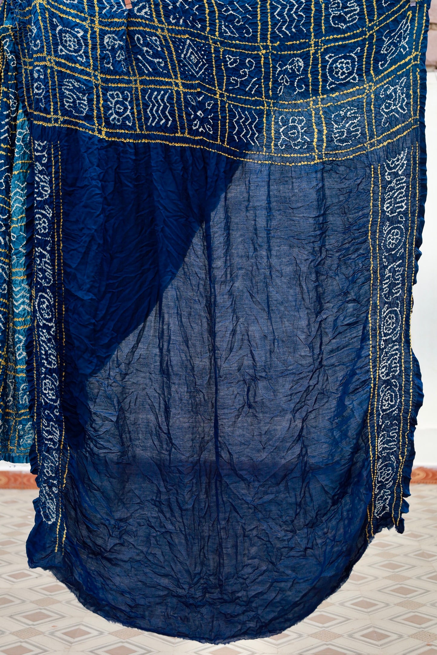 Premium midnight blue Bandhani silk saree highlighting fine artisan craftsmanship and festive elegance