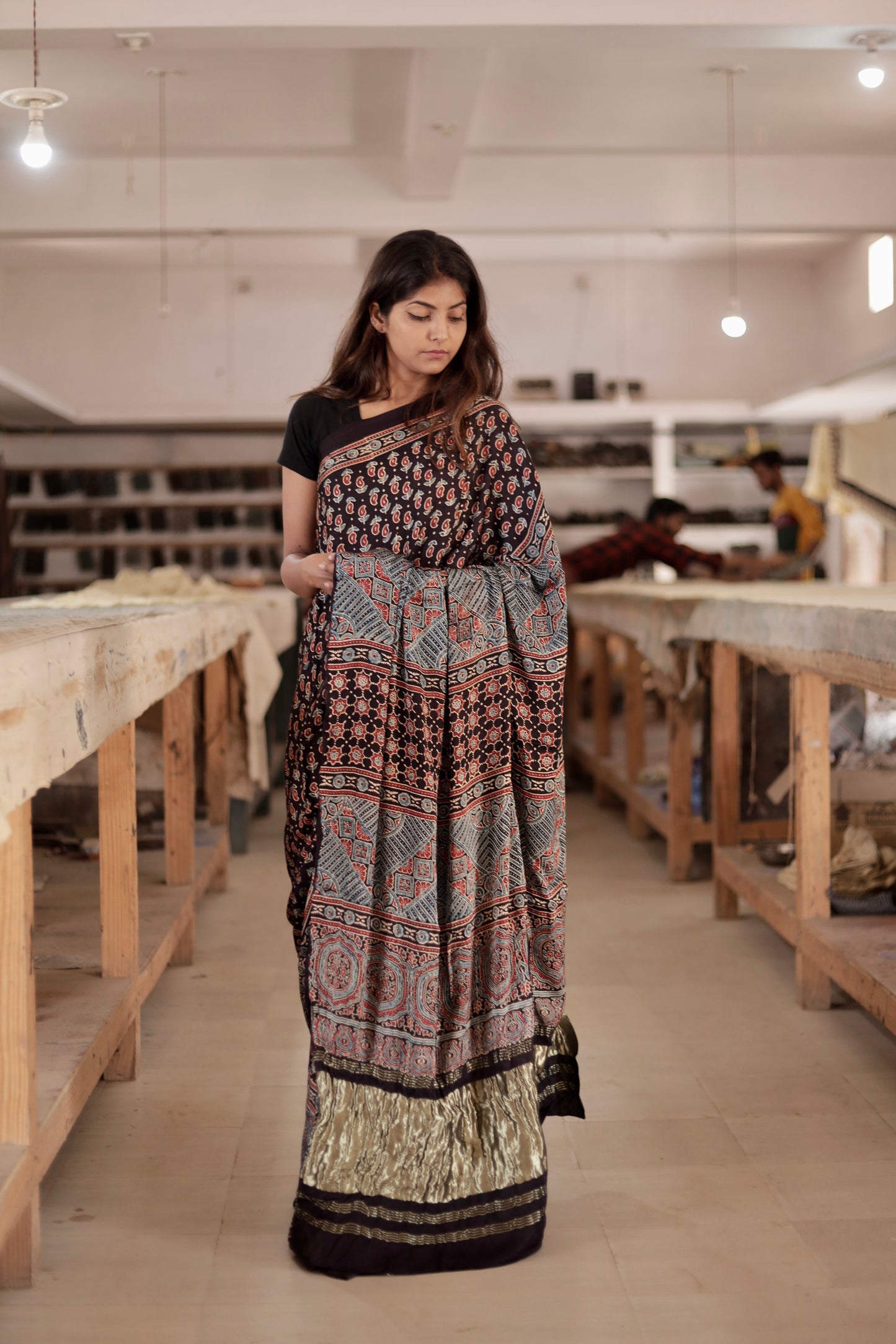 Premium black modal silk saree showcasing authentic Ajrakh craftsmanship and festive zari work