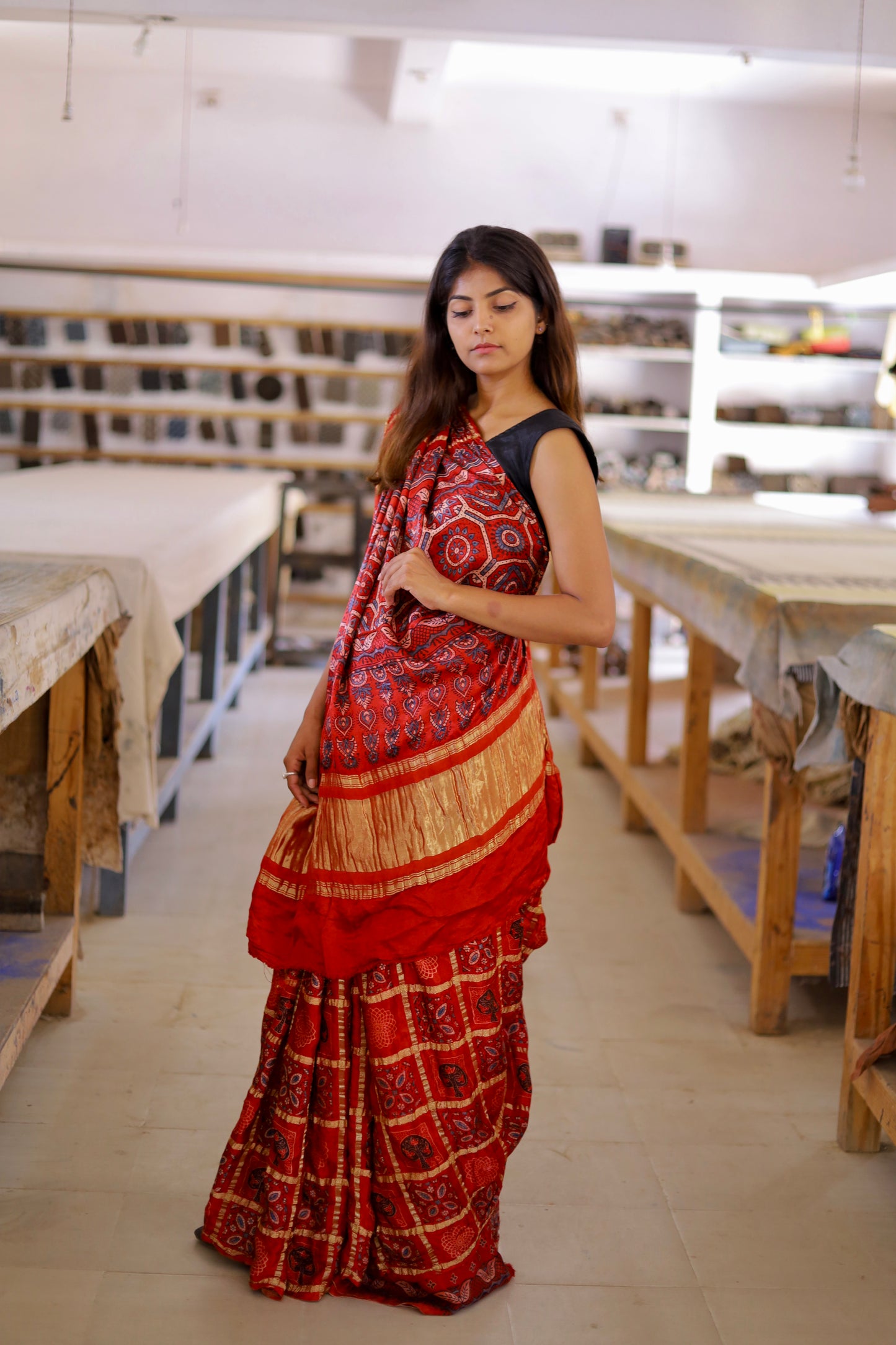 Traditional red Gharchola Ajrakh modal silk saree with rich patterns and a soft flowing texture