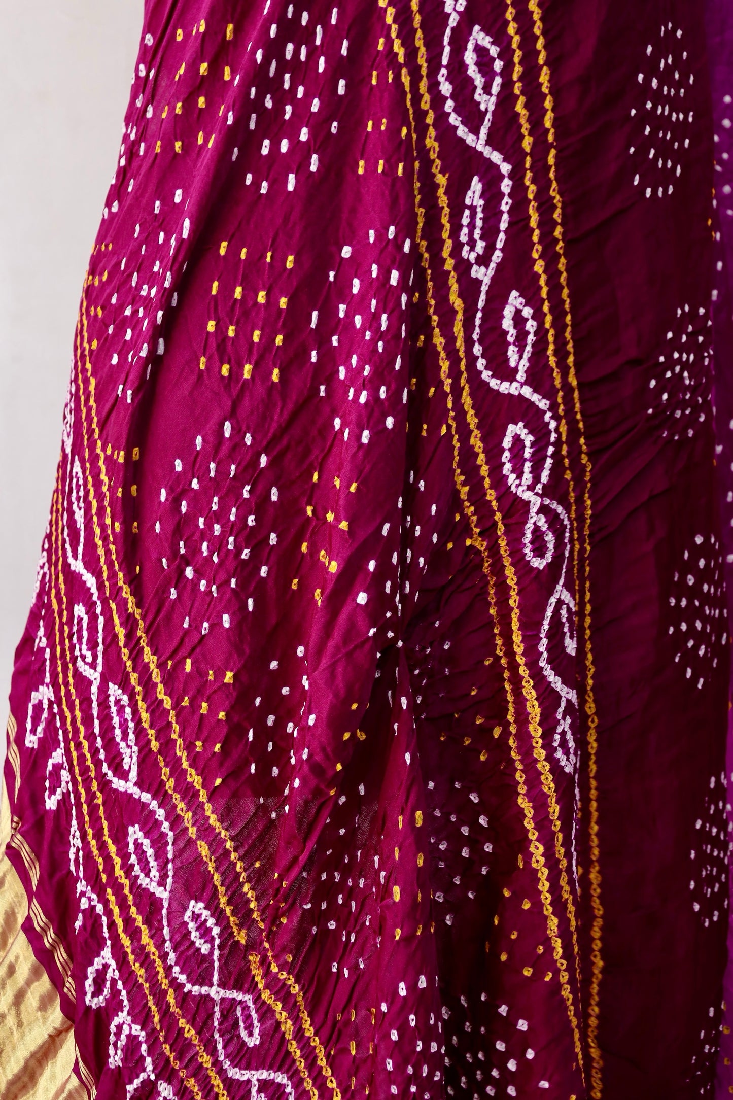 Traditional Bandhani Gajji silk saree in wine hues with a beautifully woven zari pallu