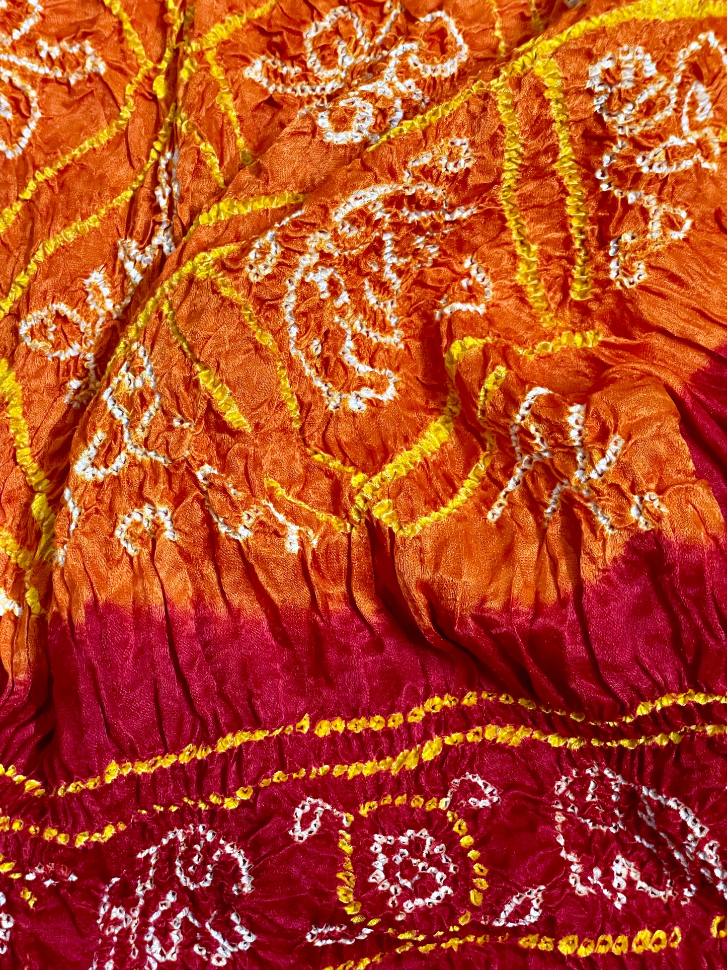 Traditional saffron orange and red Bandhani Gajji silk dupatta with intricate artisanal patterns