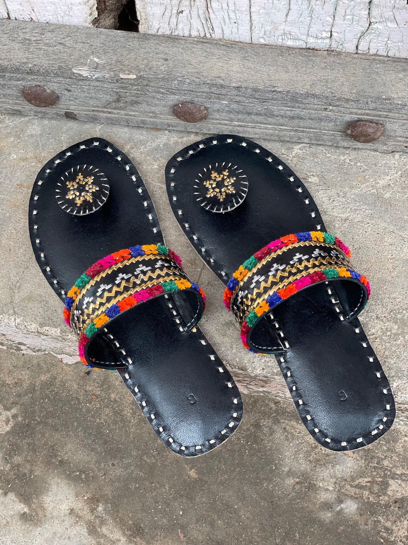 Black handstitched leather flats showcasing traditional craftsmanship and comfortable design