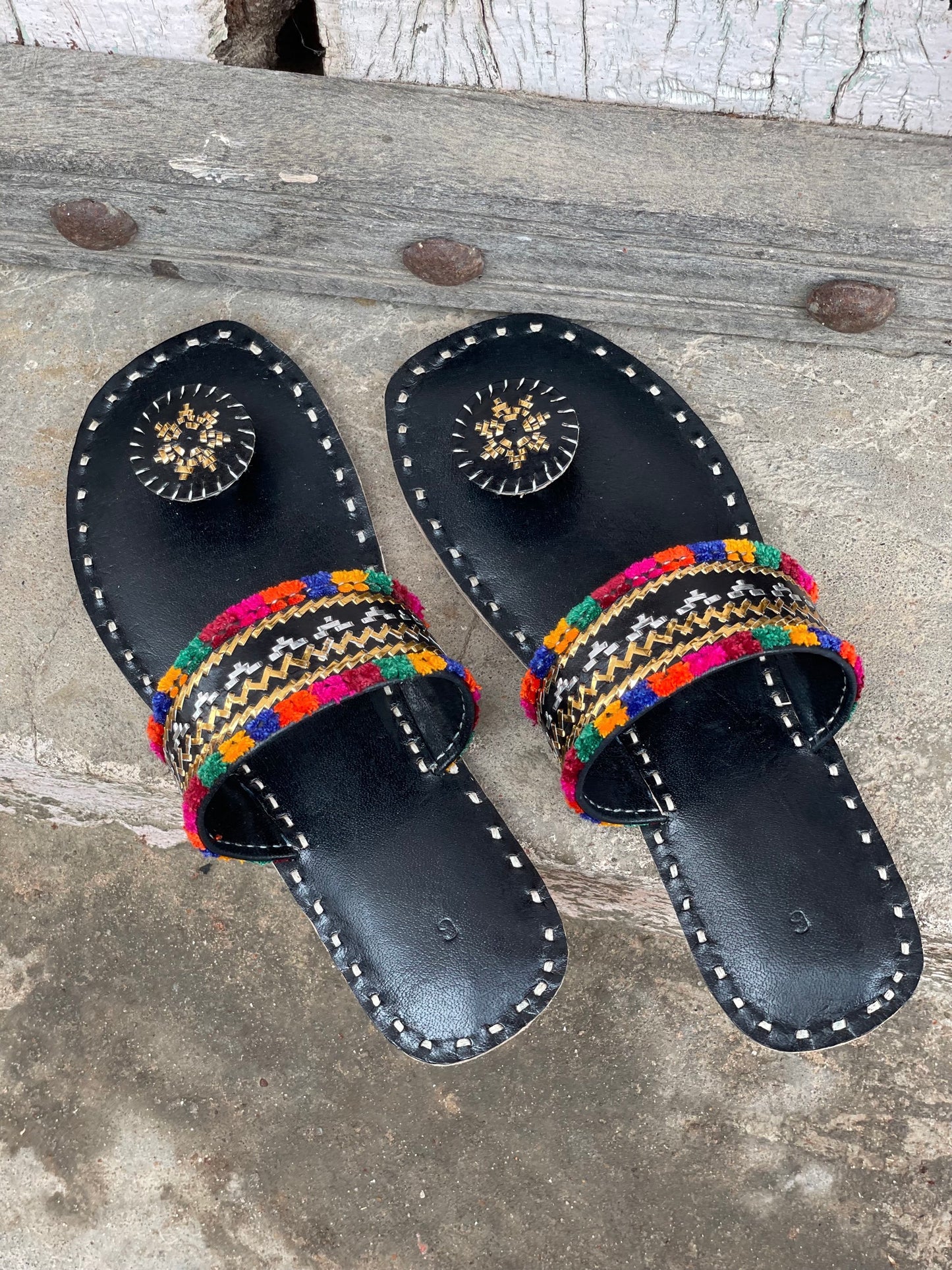 Black handstitched leather flats showcasing traditional craftsmanship and comfortable design
