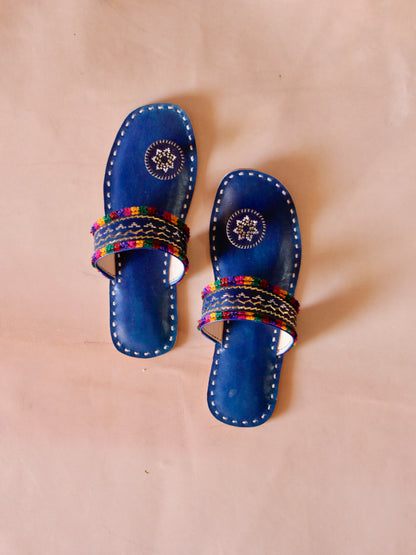 Blue handstitched leather flats showcasing traditional craftsmanship and comfortable design