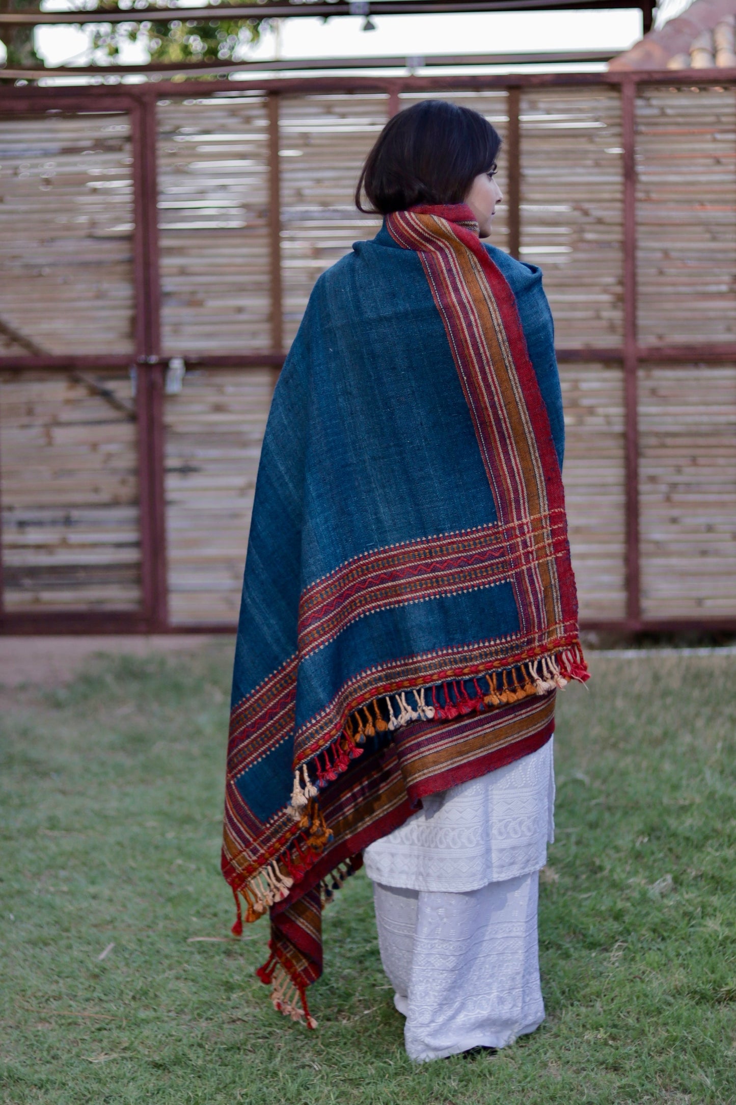 Handcrafted indigo raw wool shawl made using handspun fibers and heritage weaving techniques