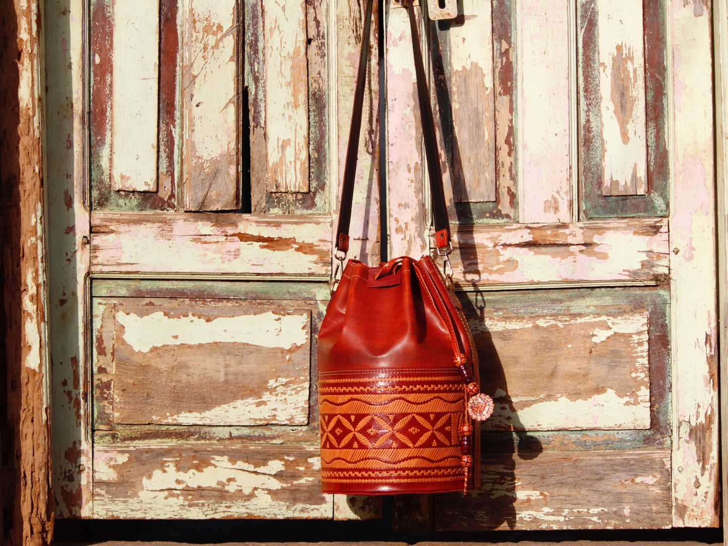 Handcrafted leather potli bag showcasing decorative thread work and heritage craftsmanship