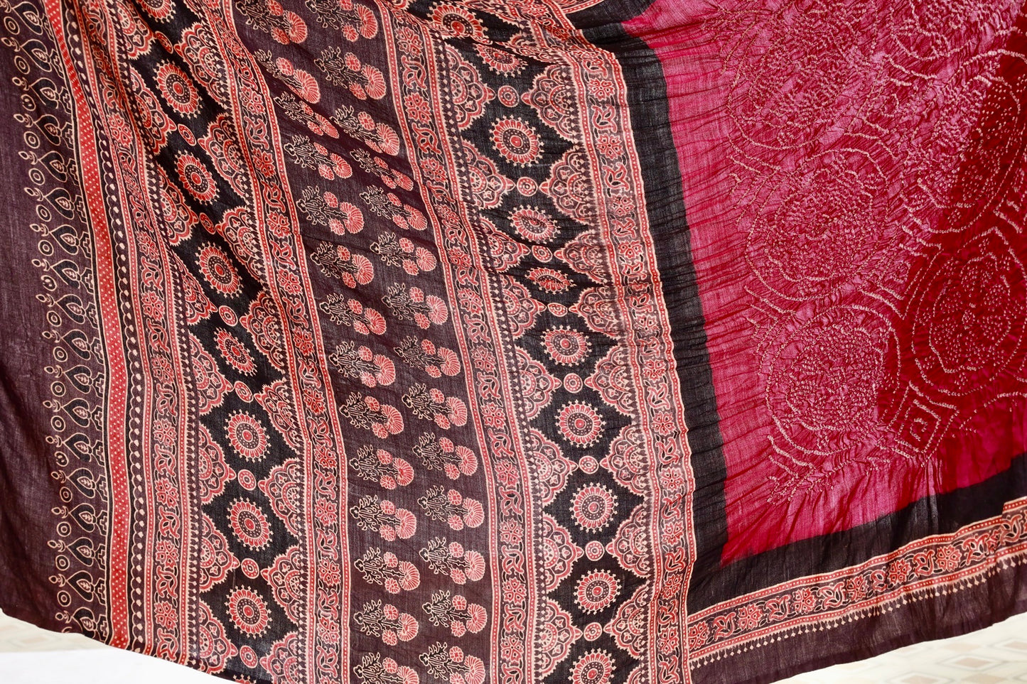 Maroon Ajrakh Bandhani silk saree featuring intricate block-printed motifs and traditional tie-dye patterns
