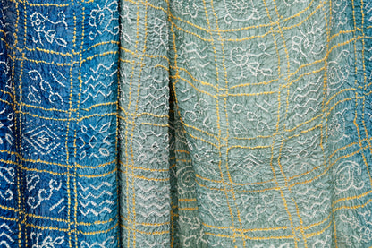 Midnight blue Rai Bandhani silk saree featuring intricate tie-dye patterns and an elegant zari pallu