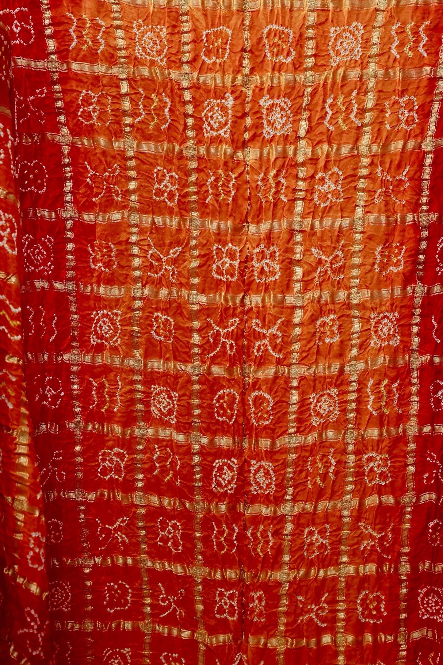 Handcrafted sunset Gajji silk saree showcasing authentic Bandhani Gharchola artistry and elegant drape