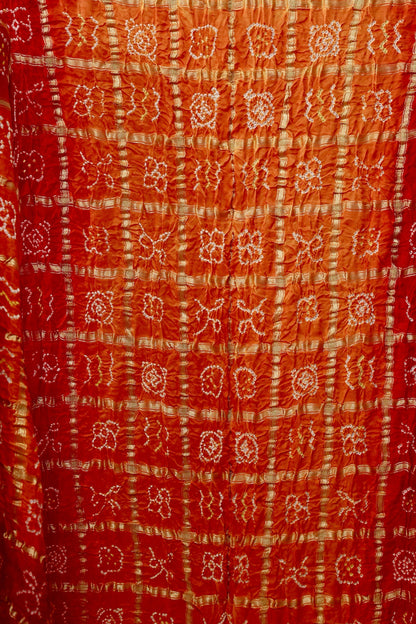 Handcrafted sunset Gajji silk saree showcasing authentic Bandhani Gharchola artistry and elegant drape