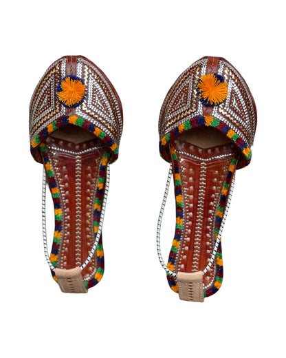 Zari handstitched leather jutti showcasing traditional craftsmanship and intricate detailing