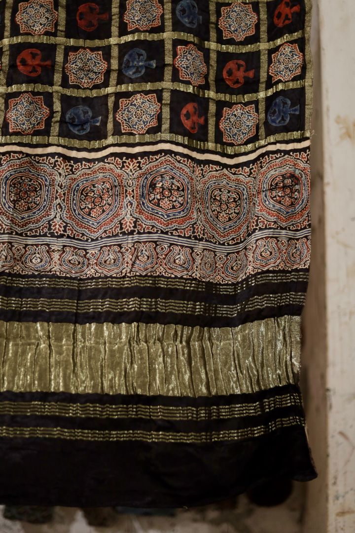 Traditional charcoal black Ajrakh modal silk dupatta showcasing authentic artisan craftsmanship and decorative borders