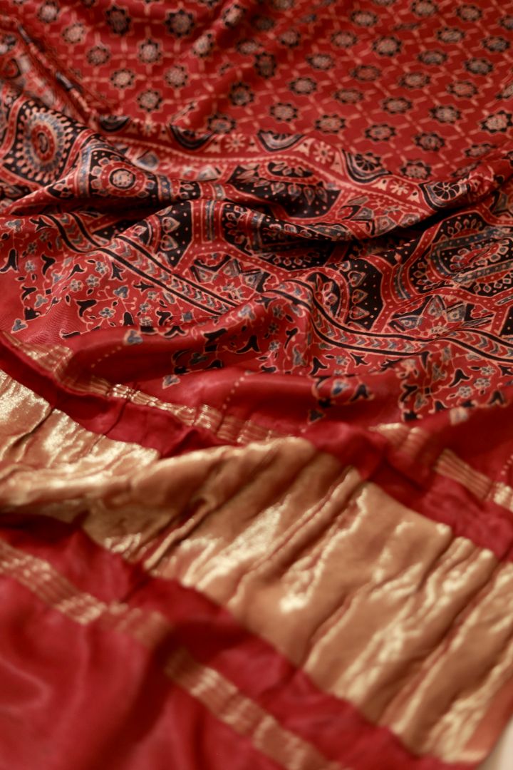 Traditional crimson red Ajrakh modal silk dupatta showcasing authentic artisan craftsmanship and decorative borders