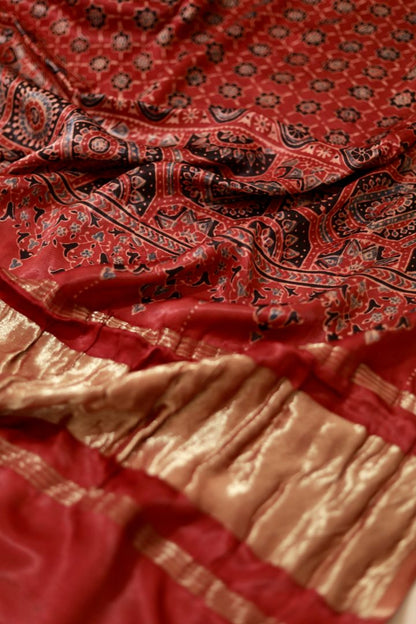 Traditional crimson red Ajrakh modal silk dupatta showcasing authentic artisan craftsmanship and decorative borders