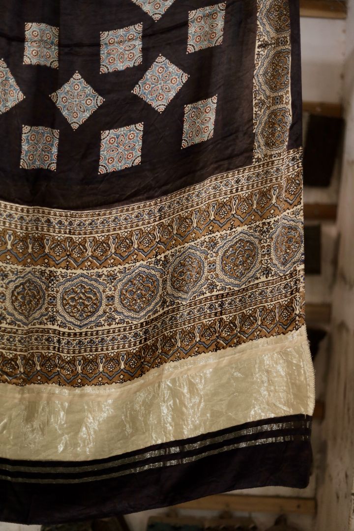 Traditional natural black Ajrakh modal silk dupatta showcasing authentic artisan craftsmanship and decorative borders