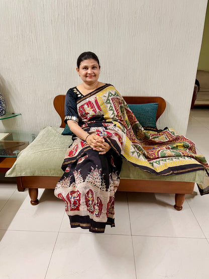Black handpainted Mata Ni Pachedi saree featuring traditional sacred motifs and intricate artisan detailing
