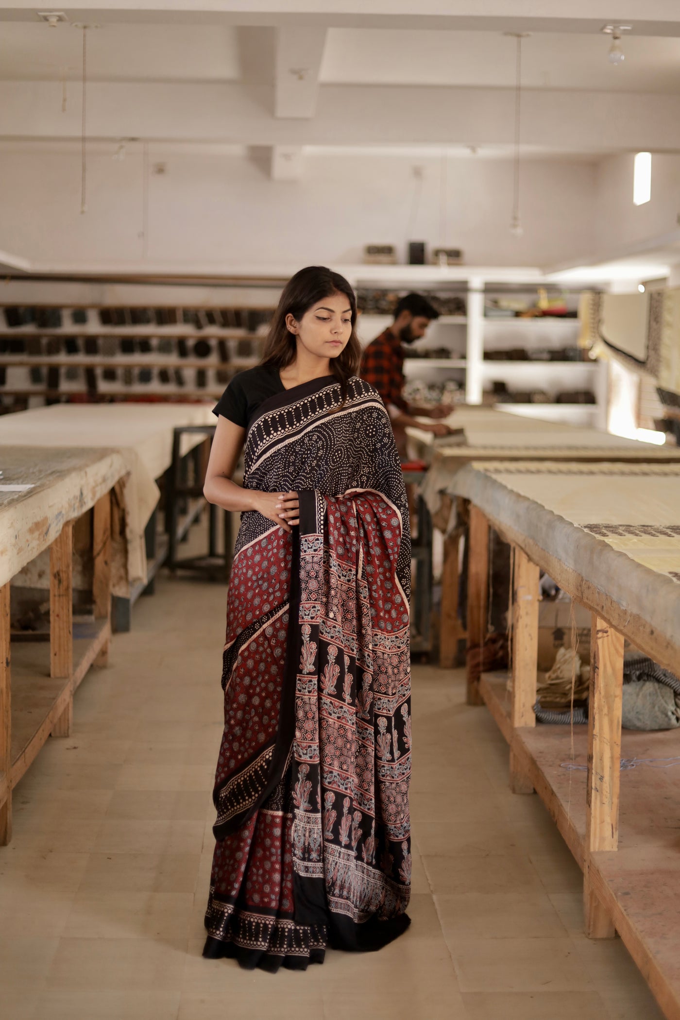 Black and maroon Ajrakh modal silk saree featuring intricate hand block printed motifs and a graceful drape