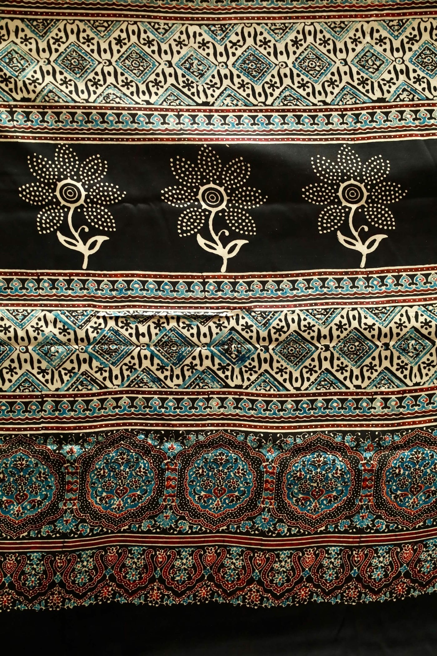 Black sunflower Ajrakh modal silk saree featuring intricate hand block printed motifs and a graceful drape