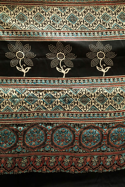 Black sunflower Ajrakh modal silk saree featuring intricate hand block printed motifs and a graceful drape