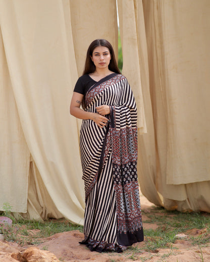 Black and white stripe Ajrakh modal silk saree featuring intricate hand block printed motifs and a graceful drape