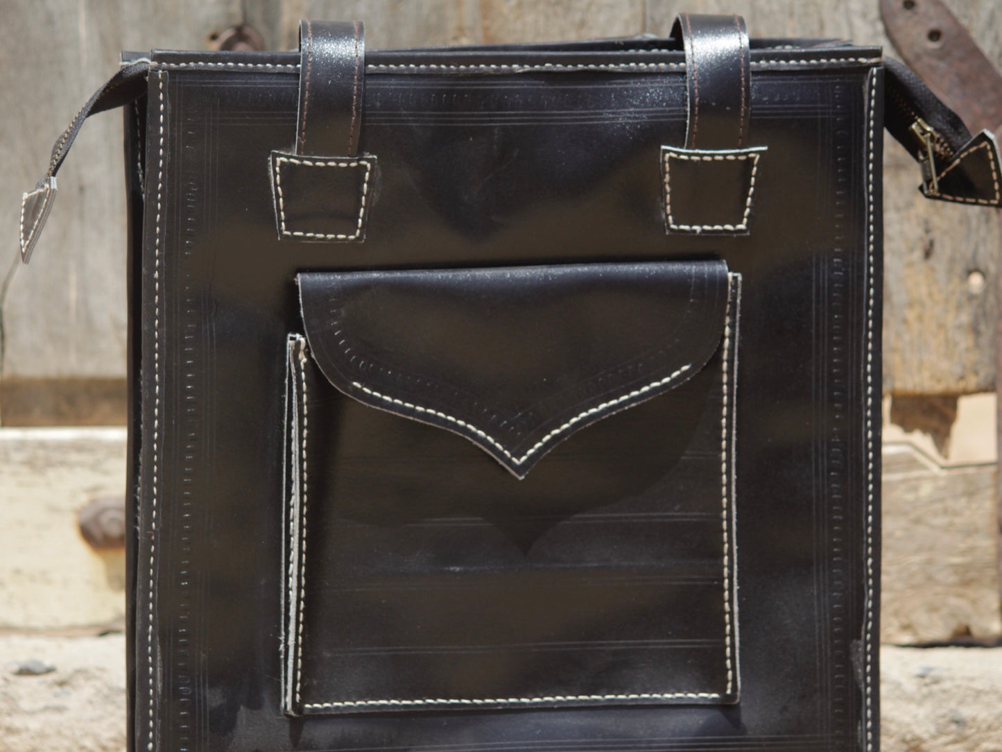 Black handstitched leather bag crafted from premium leather with meticulous handmade detailing