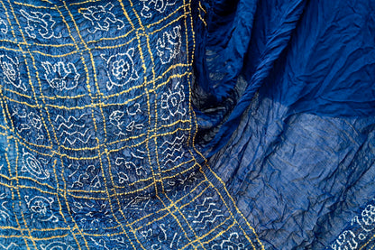 Premium midnight blue Bandhani silk saree highlighting fine artisan craftsmanship and festive elegance