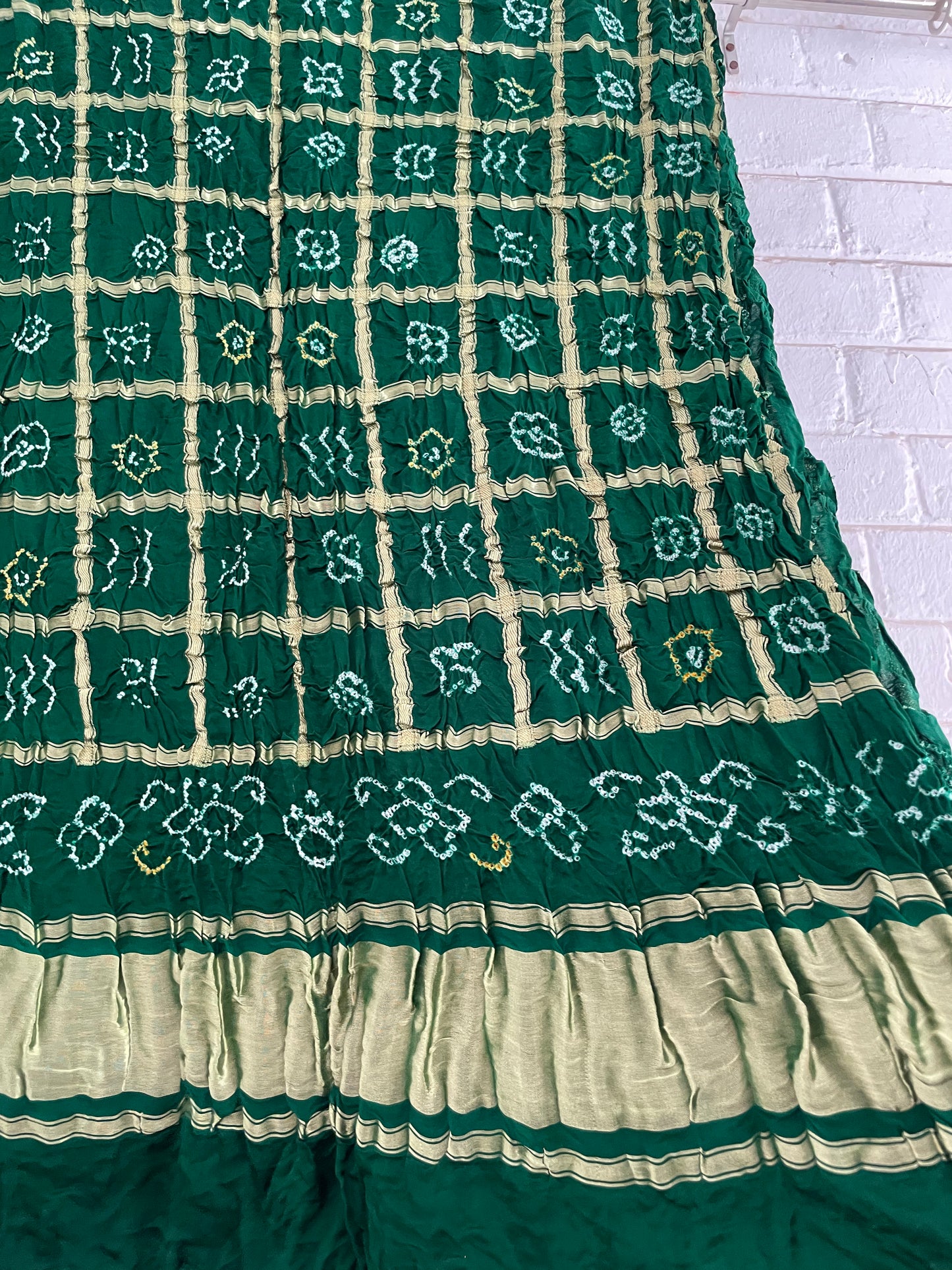 Handcrafted bottle green Gharchola dupatta featuring authentic Bandhani patterns and zari detailing