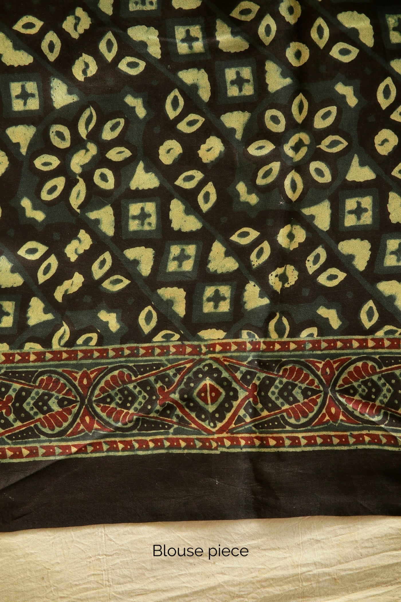 Premium bottle green modal silk saree with heritage-inspired Ajrakh designs and graceful fall. Traditional bottle green Ajrakh printed modal silk saree crafted by skilled artisans with refined detailing
