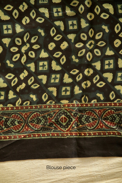 Premium bottle green modal silk saree with heritage-inspired Ajrakh designs and graceful fall. Traditional bottle green Ajrakh printed modal silk saree crafted by skilled artisans with refined detailing