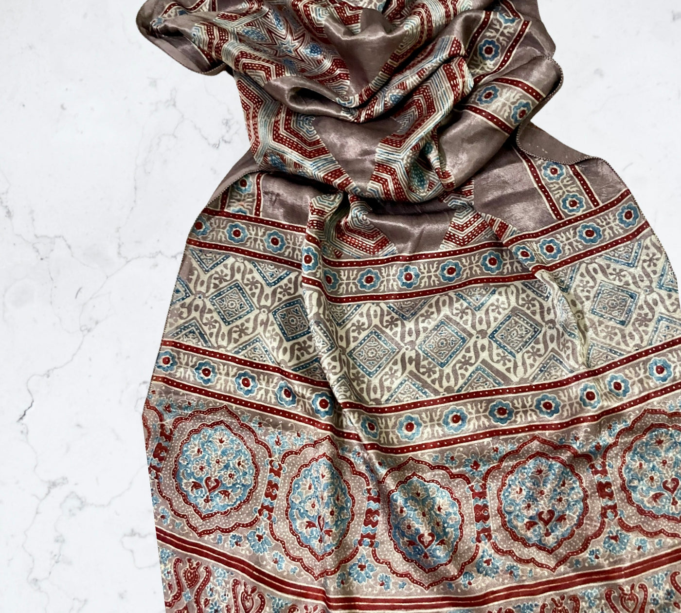 Bronze Ajrakh Mashru silk stole featuring intricate hand block printed motifs and elegant drape