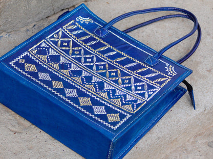 Elegant blue leather bag with shimmering zari accents and timeless appeal