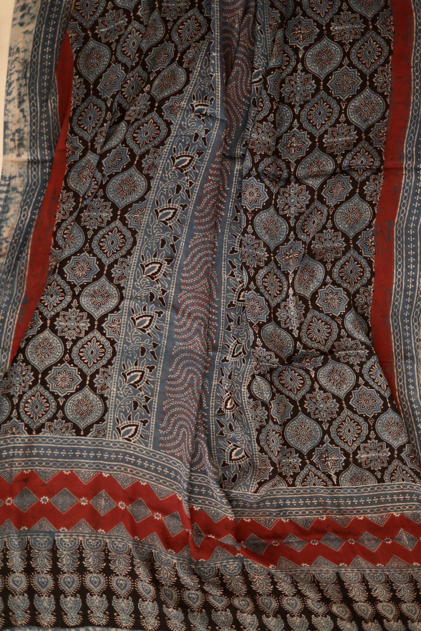 Charcoal grey Ajrakh modal silk dupatta featuring intricate hand block printed motifs and elegant drape