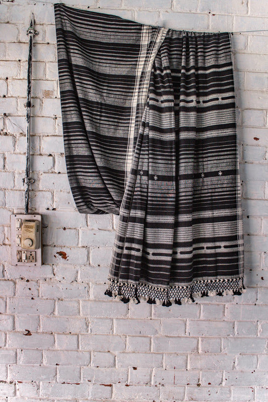 Handcrafted charcoal Kala Cotton saree adorned with authentic Bhujodi weaving and heritage-inspired motifs