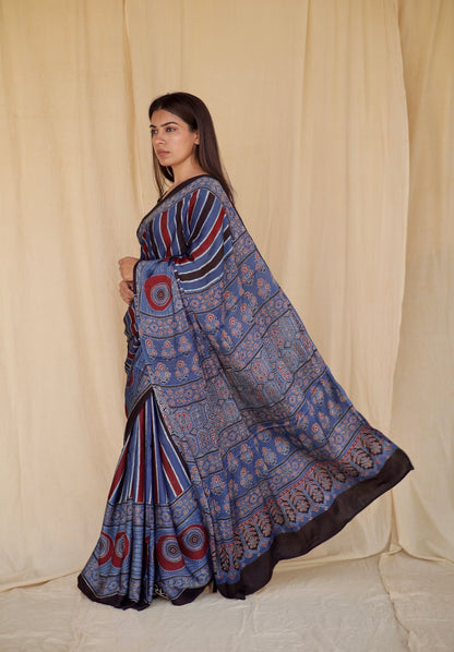 Cobalt blue Ajrakh modal silk saree featuring intricate hand block printed motifs and a graceful drape