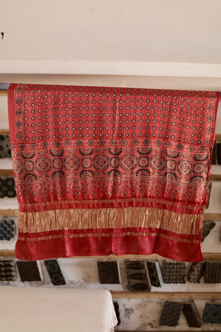 Crimson red Ajrakh modal silk dupatta with Lagdi Patta featuring intricate block printed motifs and elegant drape