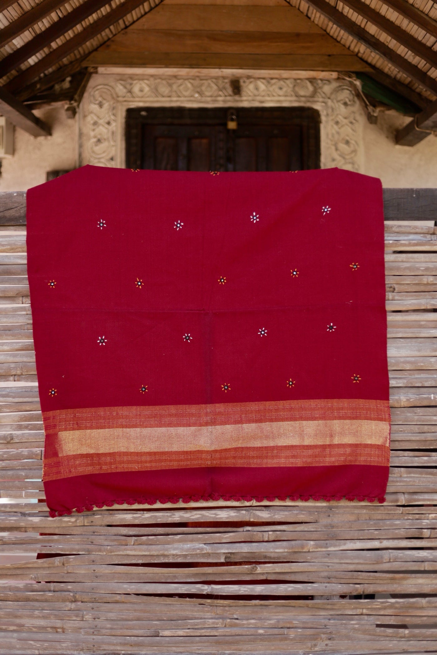 Crimson red handwoven woolen shawl featuring a rich texture and vibrant artisanal craftsmanship