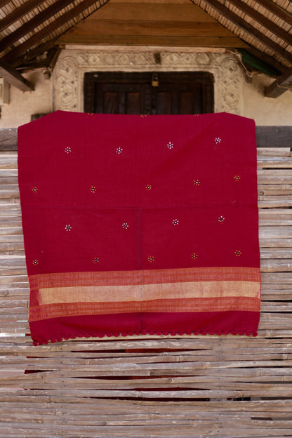 Crimson red handwoven woolen shawl featuring a rich texture and vibrant artisanal craftsmanship