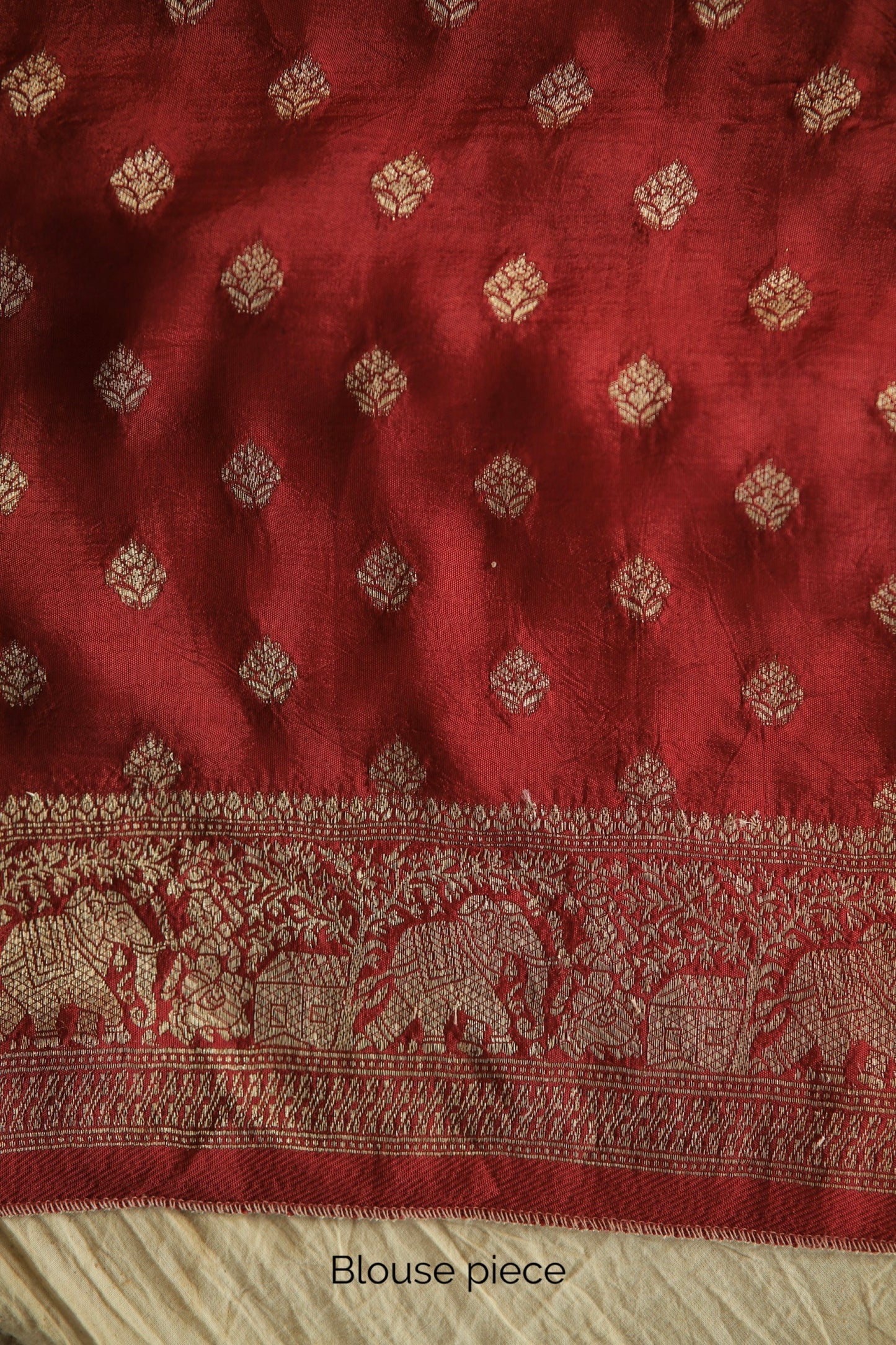 Elegant crimson red Ajrakh saree crafted in Dola silk with detailed artisan block printing. Premium crimson red Dola silk saree showcasing heritage-inspired Ajrakh designs and fluid fall