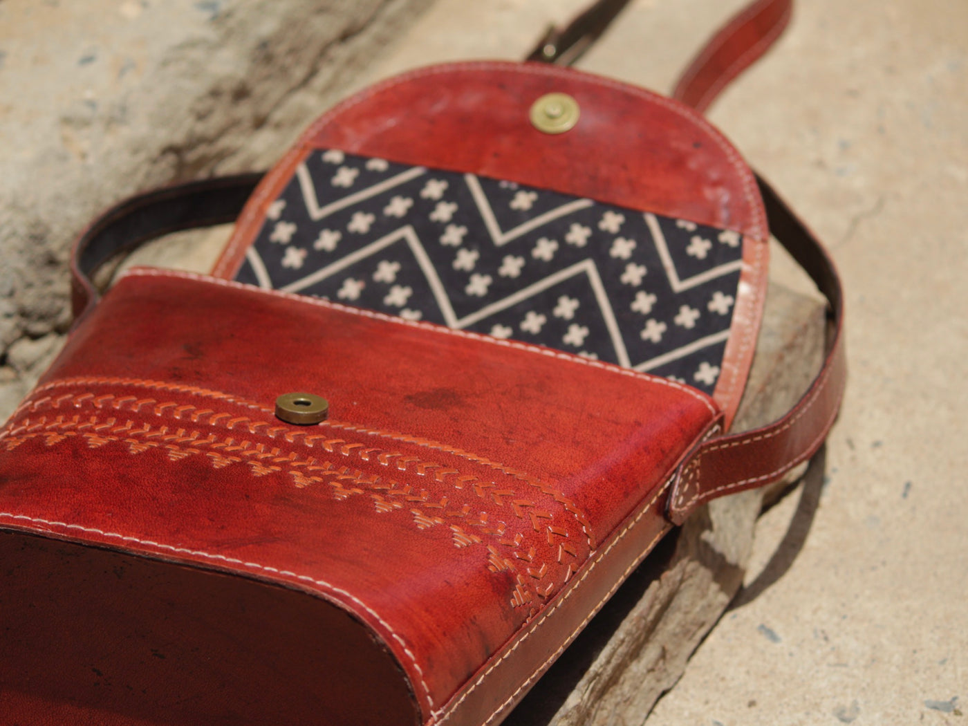 Premium leather bag combining skilled leatherwork with artistic thread detailing