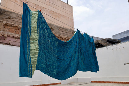 Deep sea Rai Bandhani silk saree featuring intricate tie-dye patterns and an elegant zari pallu