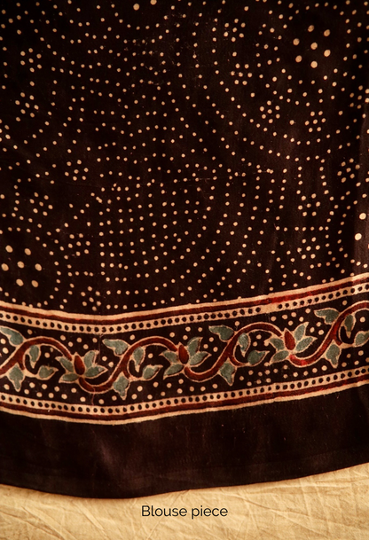 Premium deep black modal silk saree showcasing authentic Ajrakh craftsmanship and heritage-inspired motifs. Traditional deep black Ajrakh modal silk saree with rich artisanal prints and a soft flowing texture