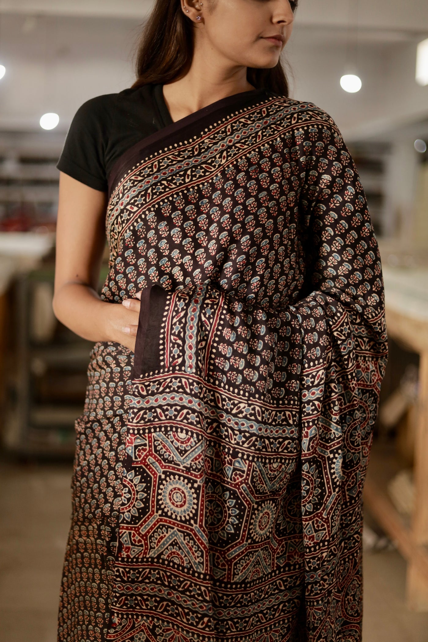 Elegant charcoal black Ajrakh saree crafted in luxurious modal silk with heritage-inspired designs